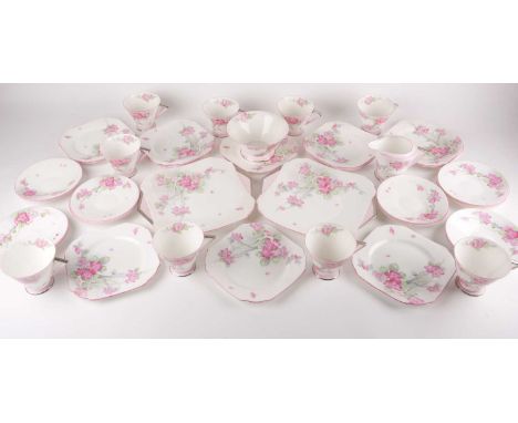 A Shelley " Apple Blossom" bone China "Eve" shaped part tea set. Painted in green and pink tones.Comprising:9 cups12 saucers1