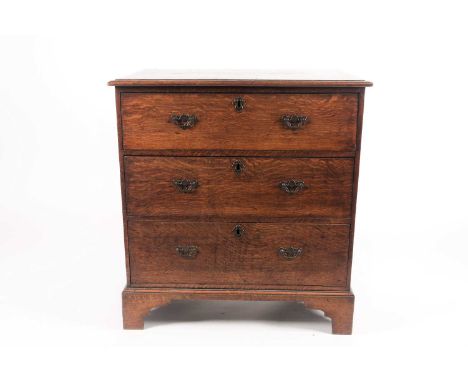 A 19th-century country-made chest of three long drawers, with clamped plank top, on shaped bracket feet. 80 cm wide x 49 cm d