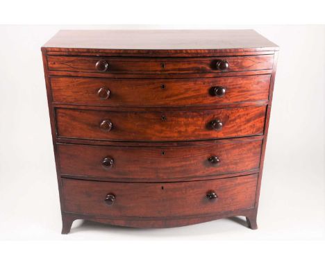 A George IV mahogany, slightly bow fronted commode chest of drawers fitted four ebony strung, long drawers. On slender splaye