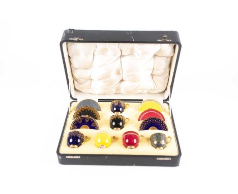 A Royal Worcester demi-tasse coffee set, early 20th century, the harlequin set with jewelled decoration, printed factory mark