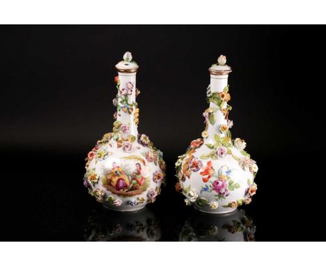 A pair of late 19th century Sitzendorf porcelain floral encrusted bottle vases and covers, painted with courting scenes and f