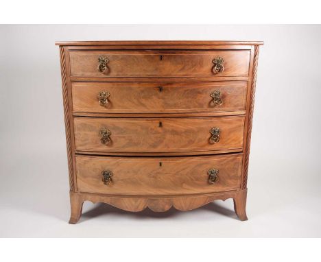 A Regency Scottish mahogany bow fronted chest of four long and graduated drawers, each with boxwood stringing with embossed f