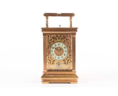 A gilt brass repeating carriage clock, with pierced rocaille work dial, with subsidiary alarm dial, flanked by fluted pilaste
