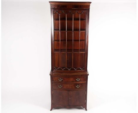 A George III style mahogany bowfront display cabinet with two drawers and a cupboard base, on bracket supports. 61 cm wide x 