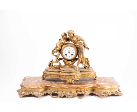 A 19th century French ormolu mantel clock with figural adornment, depicting Cupid and Venus beside the circular enamel dial, 