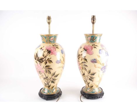 A pair of pottery table lamps, attributed to Zsolnay/Fischer, Budapest, early 20th century, decorated with lustrous flowers, 