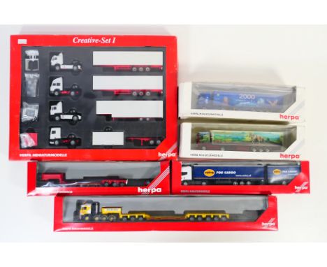 Herpa - A boxed group of 6 HO/1:87 scale plastic model trucks from Herpa. Lot includes Herpa #149242 MAN E 2000 Heavy Load Tr