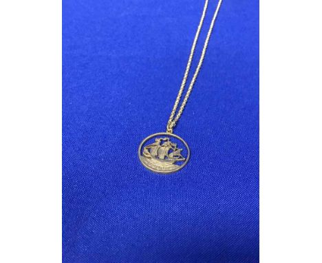 CUT COIN PENDANTthe pendant in the form of a British coin with cut out section, 25.4mm diameter unmarked, on a gold plated ch