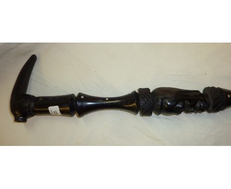 Carved ebony tribal walking stick with inlaid detail 