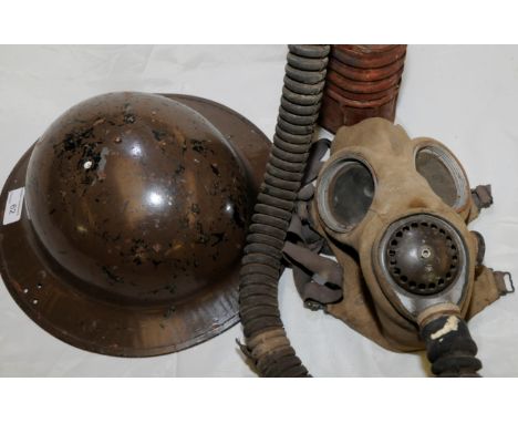 British WWII period steel helmet and a WWII period gas mask 