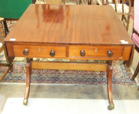 An antique mahogany drop-leaf sofa table fitted with two drawers, on sabre legs, (restored and repaired), 125cm open.