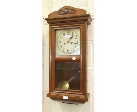 An oak case striking wall clock, 80cm high.