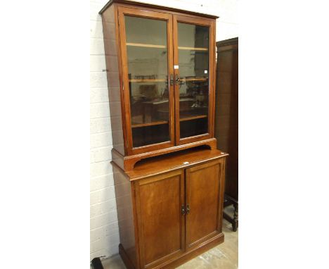 A mahogany glazed floor-standing bookcase on bracket feet, 86cm wide, 107cm high and a mahogany cupboard with two panelled do