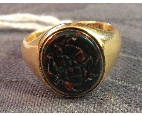 An 18ct gold signet ring set blood stone intaglio, size N.