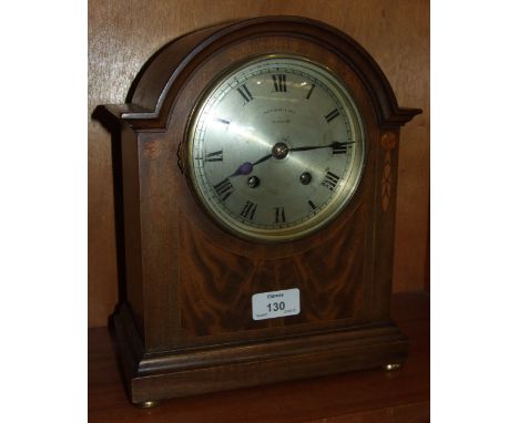 An inlaid mahogany-cased arch-shaped striking mantel clock, the movement stamped 'Astral, Coventry', the dial marked 'Page, K