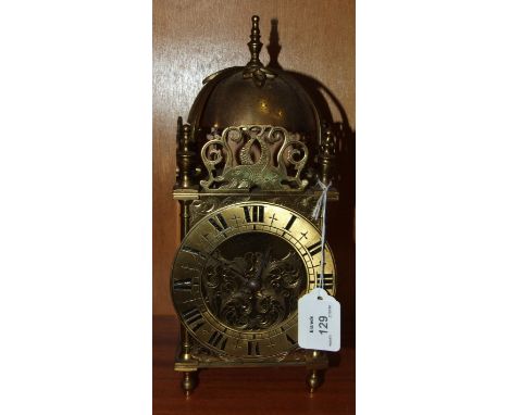 A brass lantern-style mantel clock, with clockwork movement striking on a bell, 30cm high.