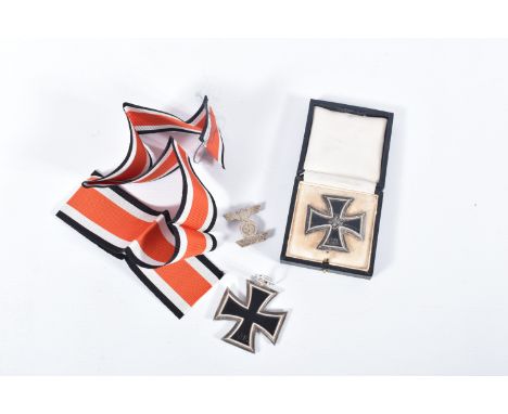 A WW2 GERMAN IRON CROSS WITH EAGLE CLASP AND ANOTHER IRON CROSS MADE BY JUNCKER, both crosses are magnetic and one has got th