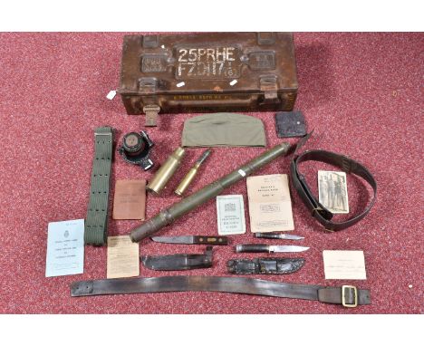 A QUANTITY OF MILITARY RELATED ITEMS, to include an ammo box, belts, WWII ephemera including pay and release books from Priva