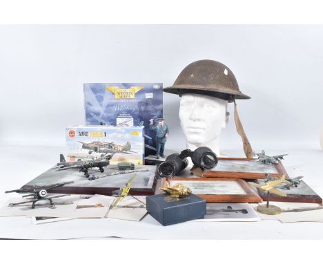 A BOX CONTAINING A WWII ERA STEEL HELMET, also include are binoculars, planes and a model of Winston Churchill, the helmet ha