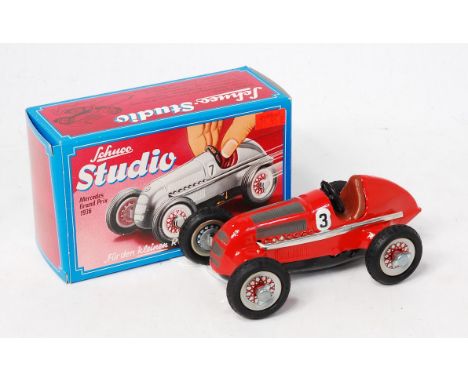 Schuco, No.1063 1936 Mercedes Grand Prix racing car, red body with brown seat and racing number 3, in the original red and bl