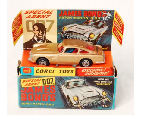 Corgi Toys, 261 James Bond's Aston martin DB5, gold body, red interior with wire wheels, 2 bandit figures, mechanism in worki