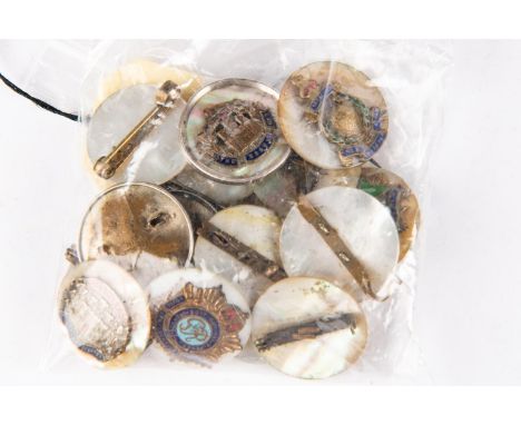 Thirteen regimental sweetheart brooches, of brass and enamel on mother of pearl discs, and three others with metal backs and 