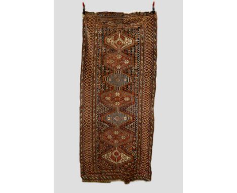Qashqa’i long rug, Fars, south west Persia, early 20th century, 8ft. 6in. x 3ft. 10in. 2.59m. x 1.17m. Overall wear, heavy in