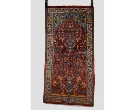 Saruk prayer rug, north west Persia, mid-20th century, 4ft. 7in. x 2ft. 3in. 1.40m. x 0.69m. Vase of flowers at the base, han