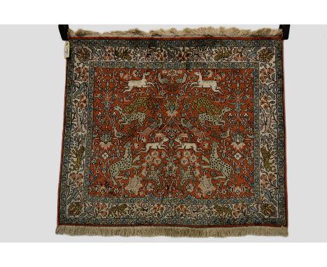 Kashmiri silk mat of hunting design, north India, late 20th century, 2ft. 7in. x 3ft. 0.79m. x 0.91m. 