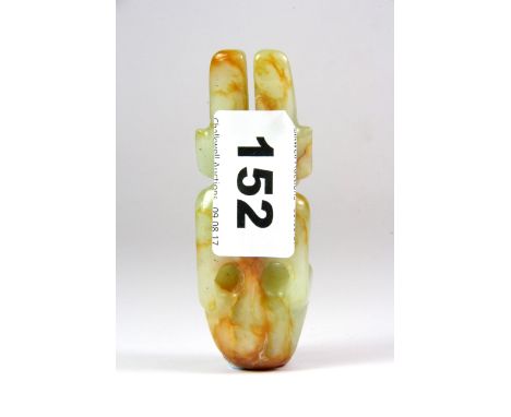 A Japanese carved jade netsuke of a horned demon, H.9cms.