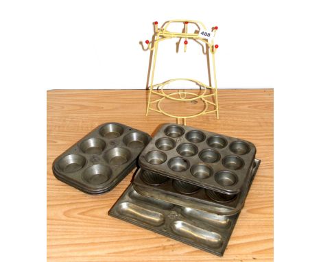 A quantity of vintage cake tins and a teaset stand.