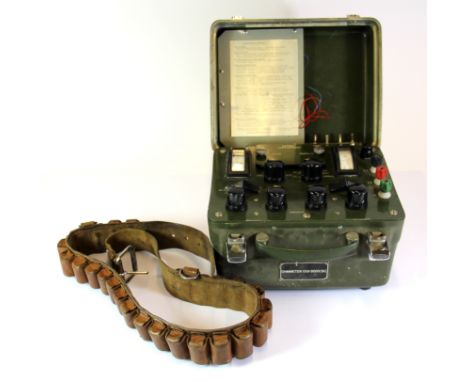 A vintage ohmmeter and gun belt.