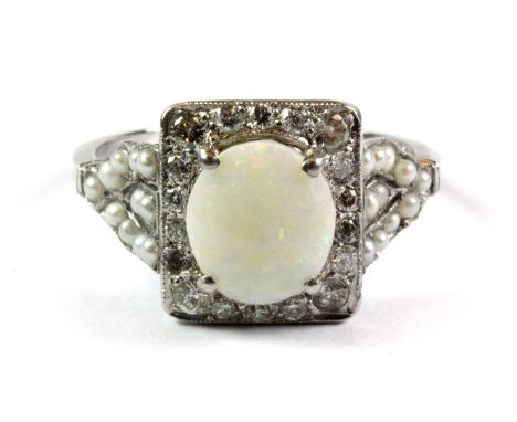 A lovely 18ct white gold (stamped 18ct) ring set with an opal, diamonds and seed pearls, (O.5).