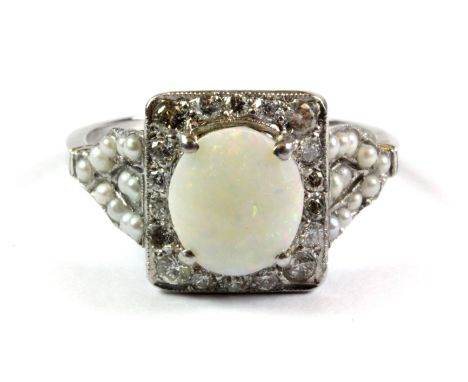 A lovely 18ct white gold (stamped 18ct) ring set with an opal, diamonds and seed pearls, (O.5).