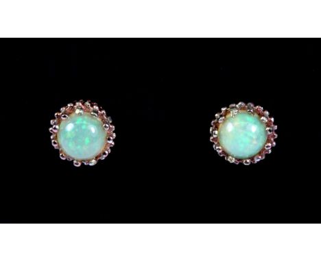 A pair of rose metal (tested minimum 9ct gold) opal set stud earrings (with no butterflies).