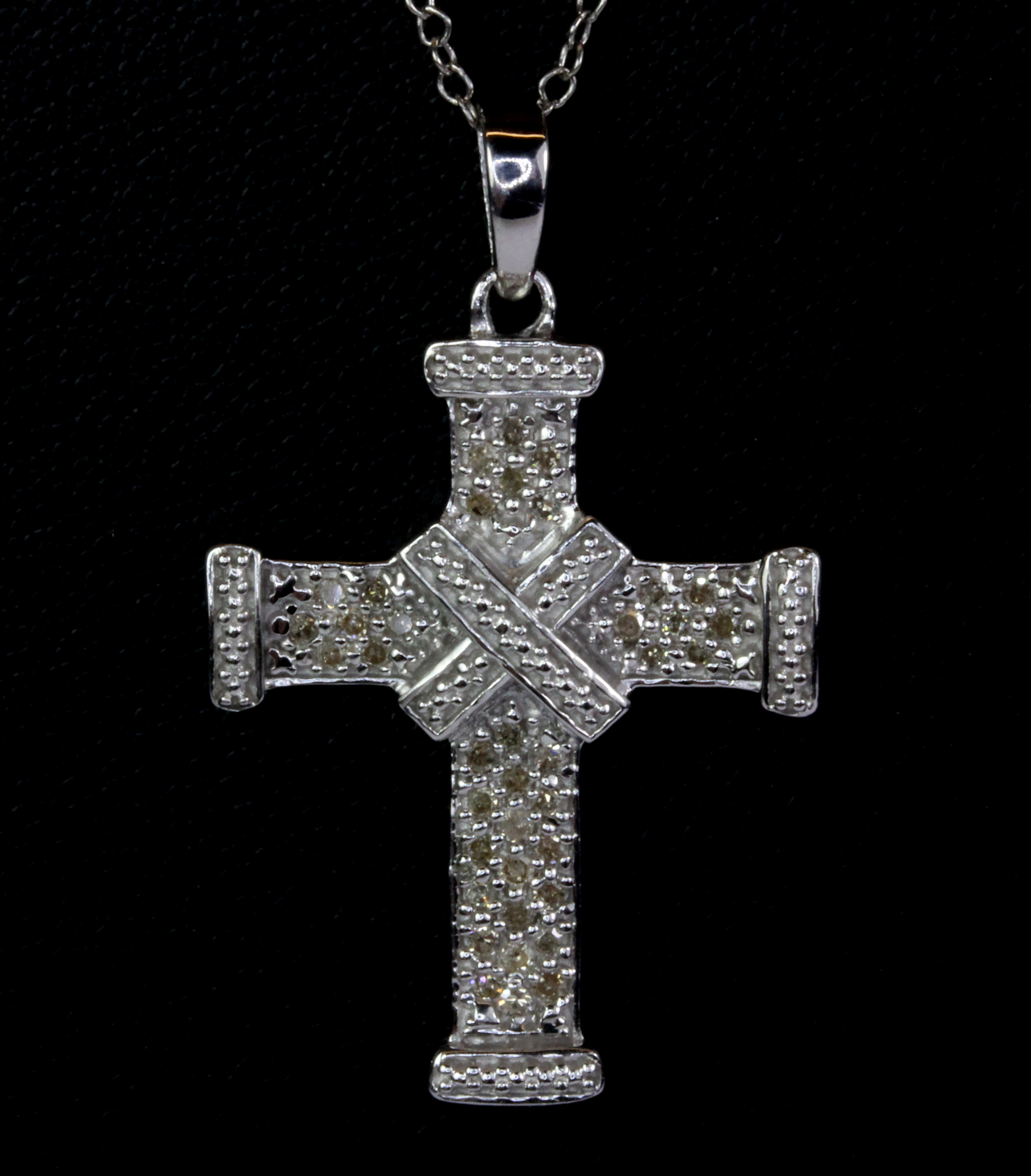 A 925 silver diamond set cross pendant and chain.