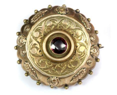 An antique yellow metal (tested minimum 9ct gold) tourmaline set brooch with a portrait locket on the back, Dia. 3.2cm.