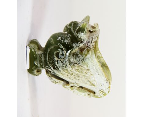 A Chinese archaic form carved jade wine cup of a phoenix holding a bowl with a dragon handle, H. 7.5cms.