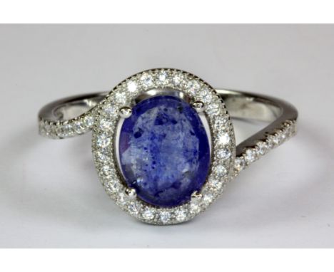 A 925 silver sapphire and white stone set ring (R.5).