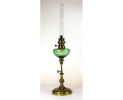 A 19th century brass and glass adjustable oil lamp, H. 61cms.