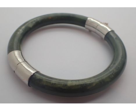 Jade bangle with yellow metal fasteners