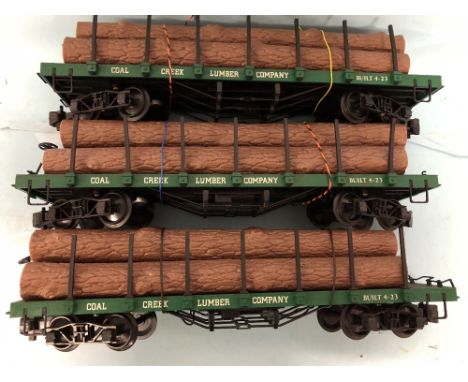 Three Bachmann G scale lumbar wagons with log loads 