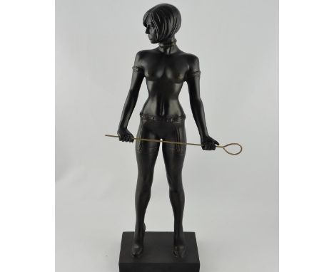 A cast resin figure of a dominatrix, scantily clad, standing in a provocative pose holding a whip, H. 54cm.