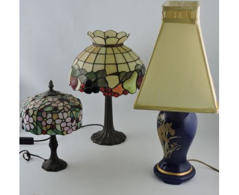 A Tiffany style table lamp, the shade decorated with fruit and berries on sinuous support, H. 42cm; together with another sim