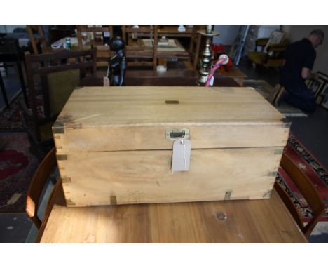 Early 20th Century brass mounted bleached camphor wood trunk with iron side handles.  Width 80cm.