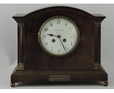An Edwardian mahogany bracket clock by Walker and Hall, the white enamel dial set out in Arabic numerals, the case with a pre