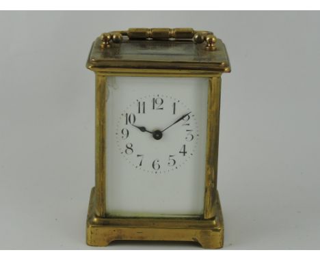 A 20th century French carriage clock, the corniche case with a white enamel dial set out in Arabic numerals, H. 12cm. 