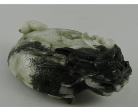 A carved jade desk weight in the form of a mythical beast, with a hard shell and a dragon head, W. 15cm