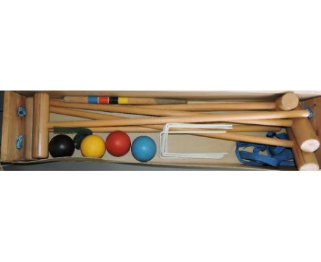 A full-size croquet set, comprising four mallets, hoops, balls and pegging out stick, in a cardboard box.