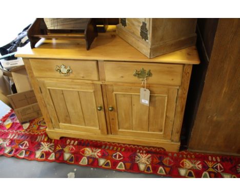 A Victorian design pine low cabinet fitted 2 drawers over panelled cupboards on bracket feet, W. 102 cm